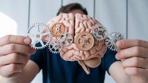 A visual representation of Chain-of-Thought Prompting (CoT) overcoming cognitive biases, with gears in the brain being replaced for clearer, unbiased thinking